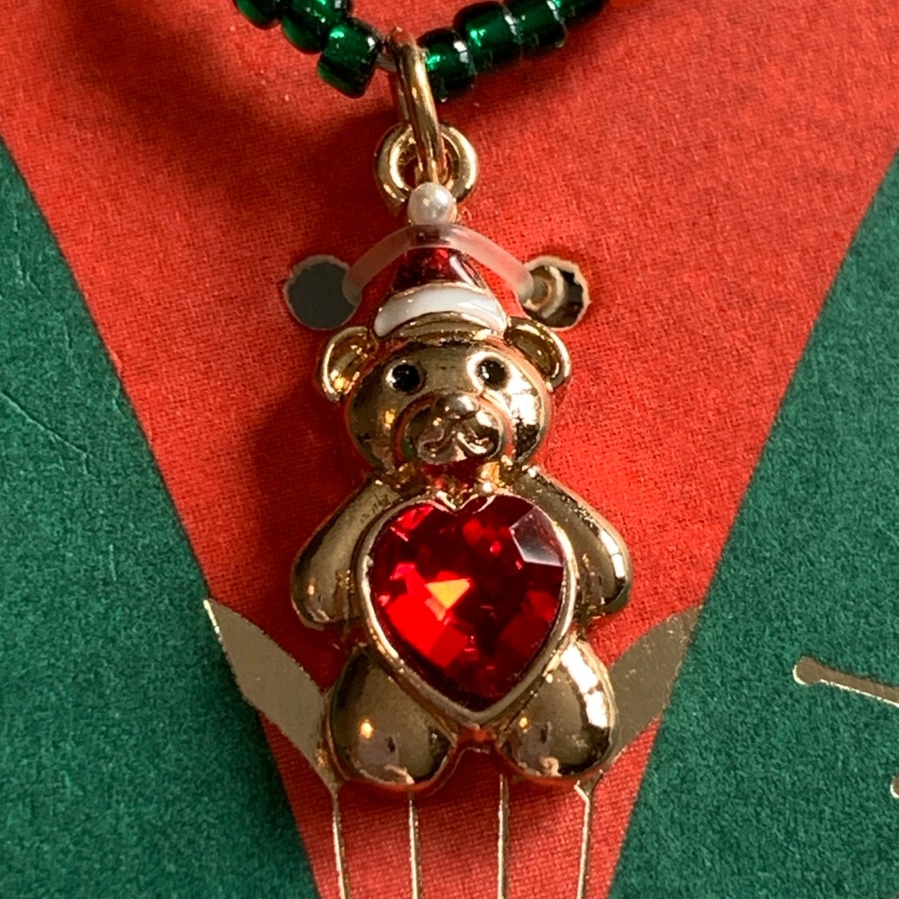 Sweet little Christmas bear necklace with red heart belly.